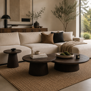Modern living room with beige sofa, dark wood coffee table, and decorative elements.