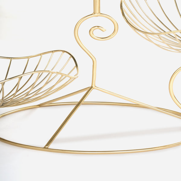 Gold wire wall art with leaf design on a white background