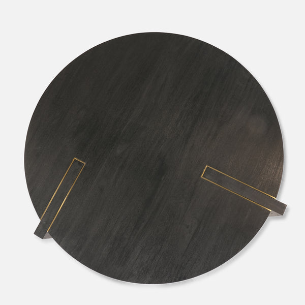 Round dark wood table with gold accents on a light gray background