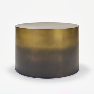Round metallic table with gradient finish on a white background