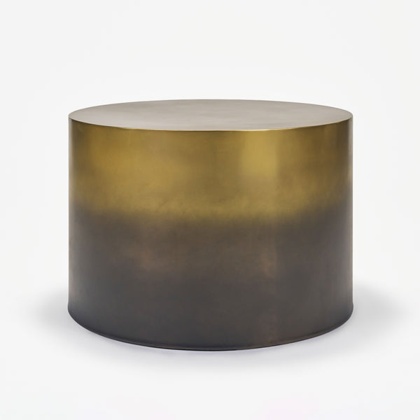 Round metallic table with gradient finish on a white background