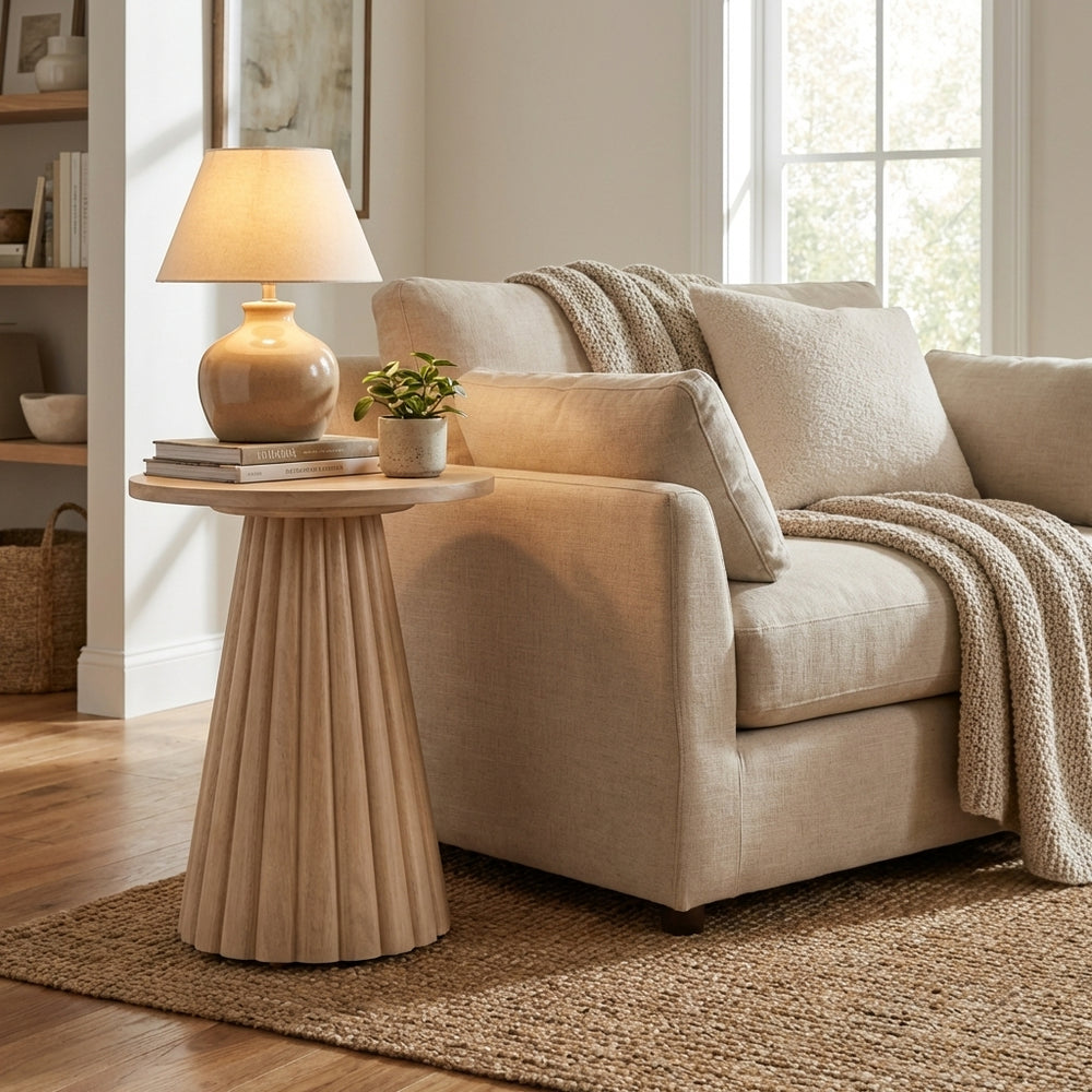 Cozy living room with a beige armchair, side table, and lamp.