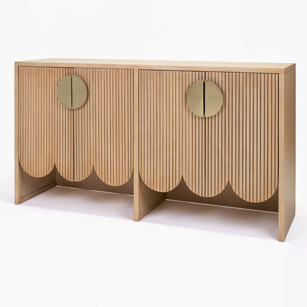Wooden console table with scalloped edge design on a white background