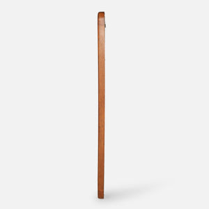 Wooden broom leaning against a white wall
