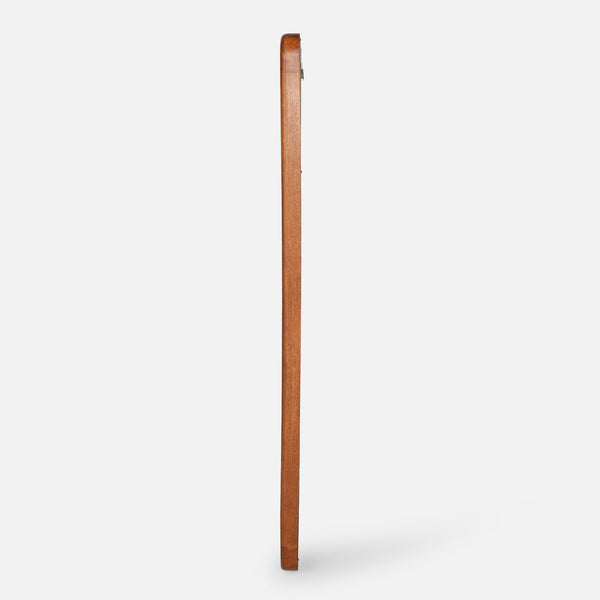 Wooden broom leaning against a white wall
