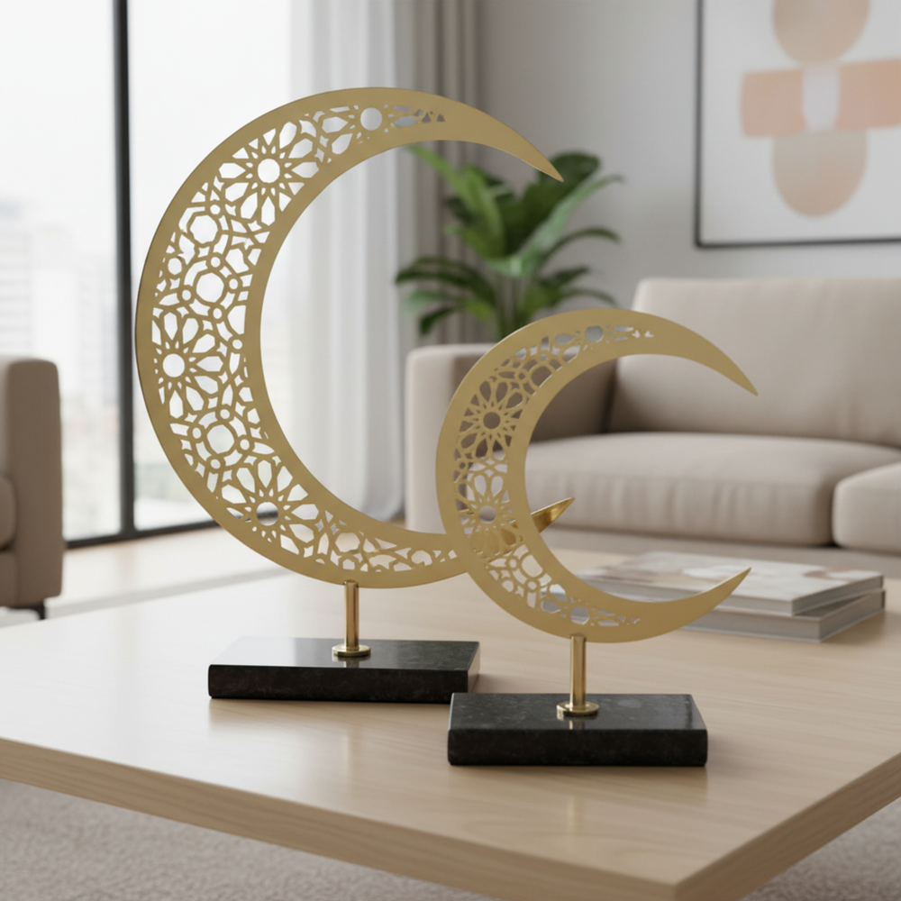 Decorative metal crescent moon sculptures on a table in a living room setting.