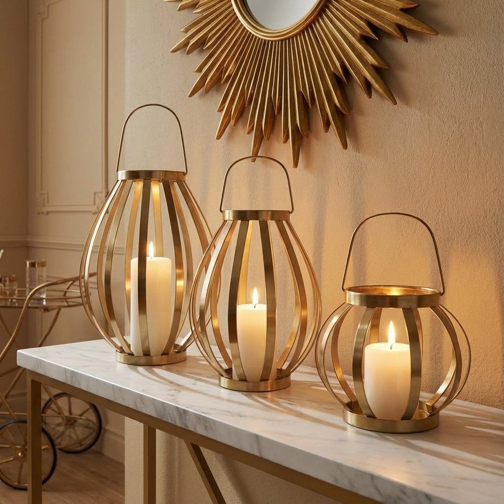 Three gold lanterns with candles on a marble surface, wall mirror in the background