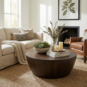 Living room with a beige sofa, brown armchair, and wooden coffee table.